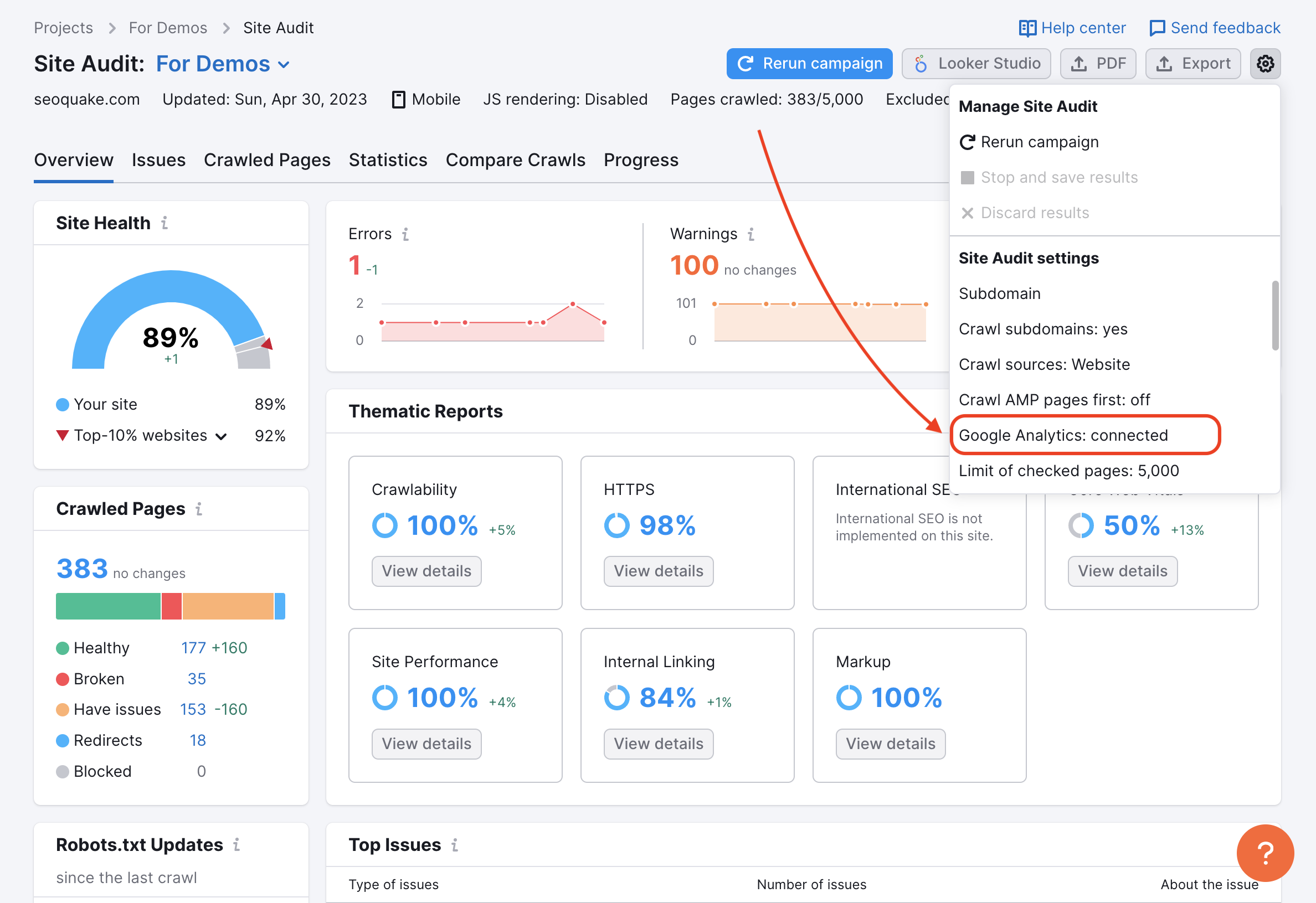 Site Audit Overview with a red arrow pointing to the Google analytics integration in the drop-down settings menu in the top-right corner.